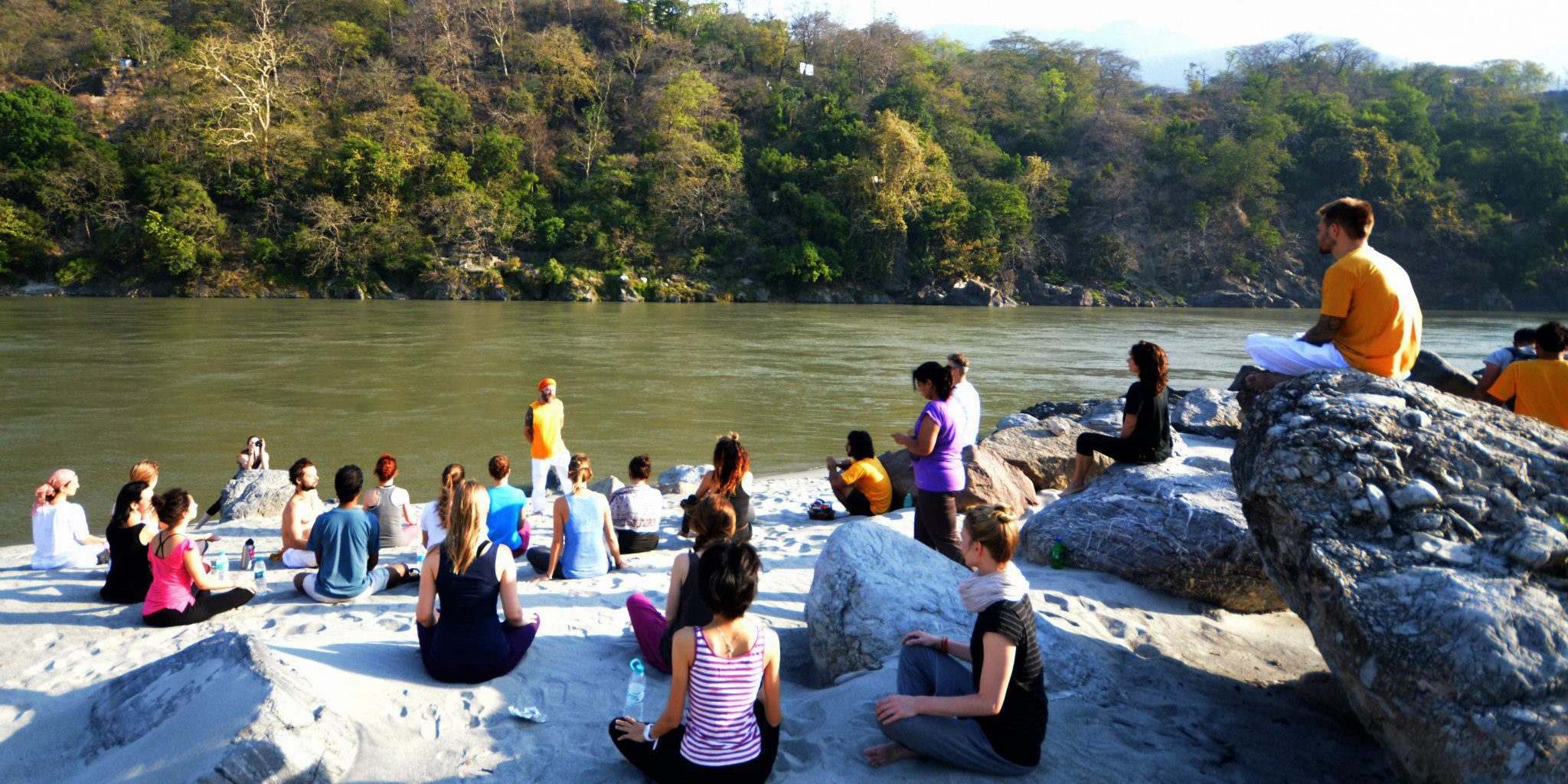 Yoga students gather besides the Ganges River