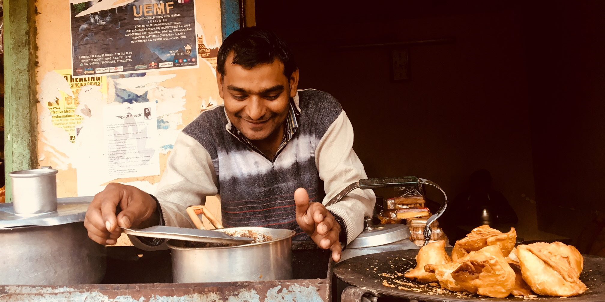 Indian man serving samosa